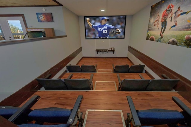 cinema room featuring baseboards and wood finished floors