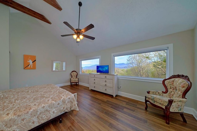 bedroom featuring wood finished floors, baseboards, and high vaulted ceiling