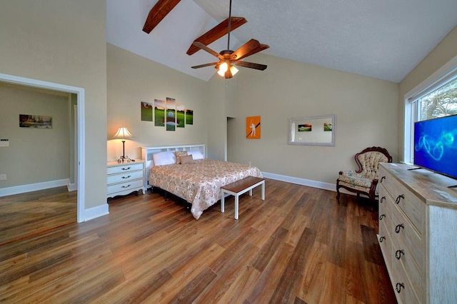 bedroom with a ceiling fan, wood finished floors, baseboards, and high vaulted ceiling