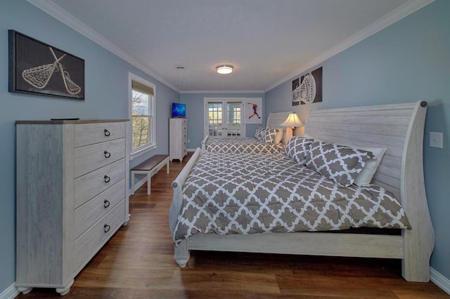 bedroom with baseboards, wood finished floors, and crown molding
