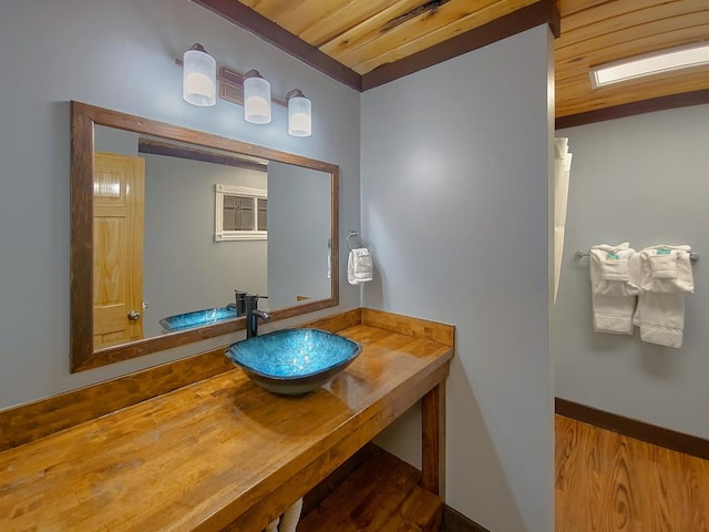bathroom with wood ceiling and vanity