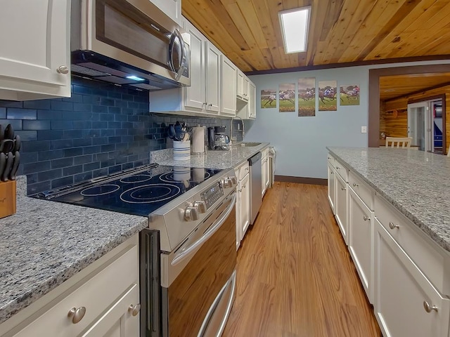 kitchen with a sink, appliances with stainless steel finishes, wooden ceiling, and white cabinetry