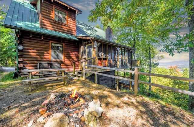 3831 Glenview Way, Sevierville, TN 37862 - back of property with a chimney, an outdoor fire pit, log siding, and a metal roof