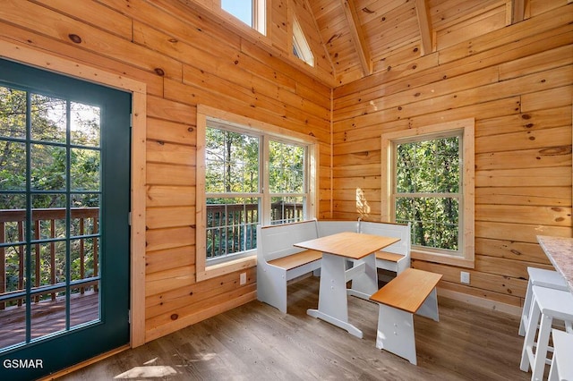833 Park Dr, Gatlinburg, TN 37738 - dining space with plenty of natural light, high vaulted ceiling, wooden walls, and wood finished floors