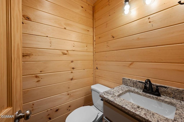 833 Park Dr, Gatlinburg, TN 37738 - bathroom featuring toilet, vanity, and wooden walls