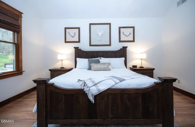 bedroom with dark wood-type flooring