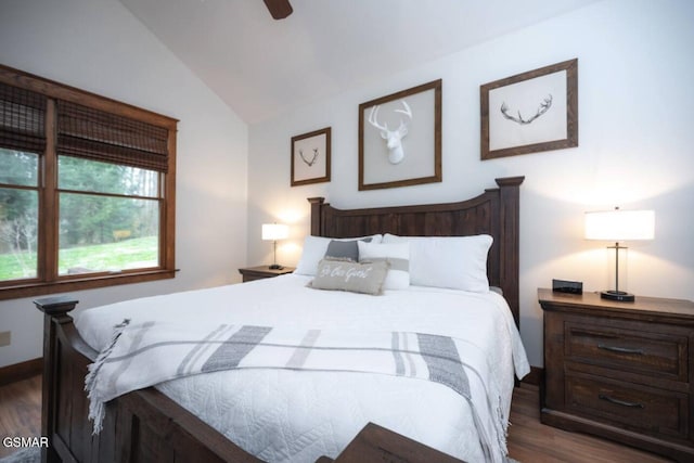 bedroom featuring lofted ceiling, dark hardwood / wood-style flooring, and ceiling fan