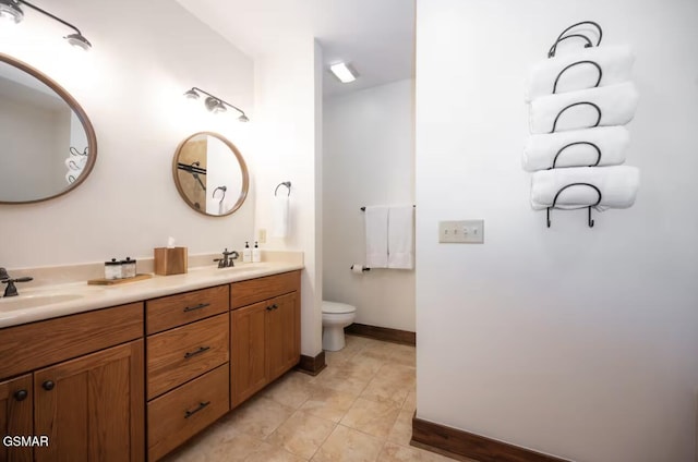 bathroom featuring tile patterned flooring, vanity, and toilet