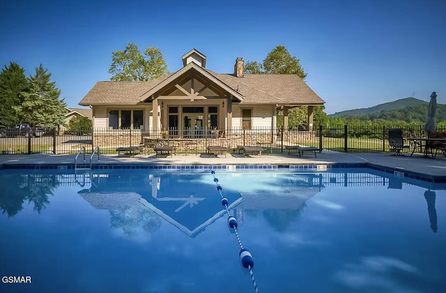 view of swimming pool featuring a mountain view and a patio