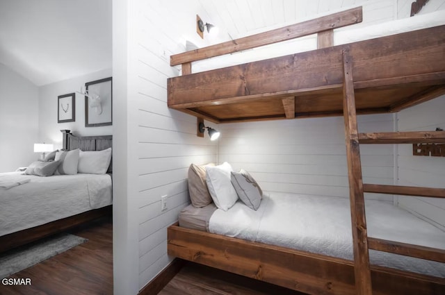 bedroom with dark wood-type flooring and vaulted ceiling