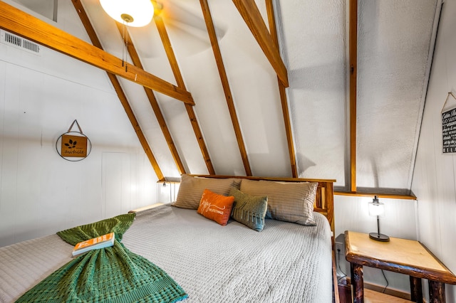 bedroom with lofted ceiling with beams