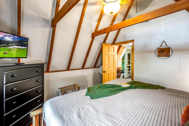 bedroom with lofted ceiling with beams