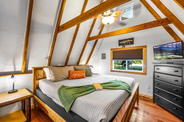 bedroom with ceiling fan, beamed ceiling, wood-type flooring, and high vaulted ceiling