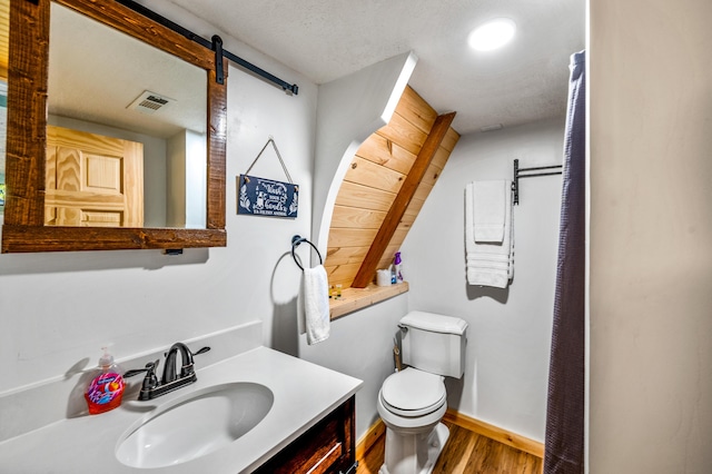 bathroom featuring hardwood / wood-style floors, vanity, and toilet