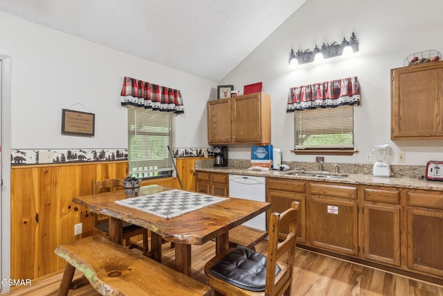 2108 Redmond Way, Sevierville, TN 37876 - kitchen with a sink, lofted ceiling, brown cabinetry, light wood-type flooring, and wainscoting