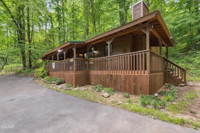 2108 Redmond Way, Sevierville, TN 37876 - chalet / cabin with a chimney, a porch, a wooded view, and stairs