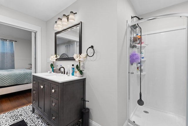 bathroom with tile patterned floors, a shower, and vanity