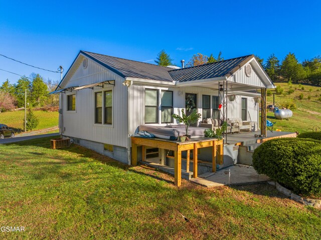 rear view of property with a lawn