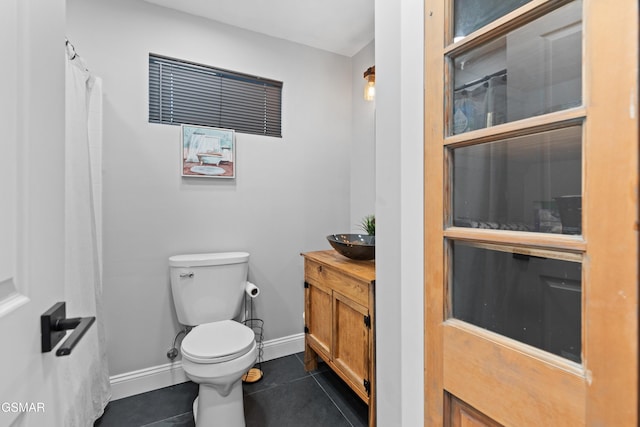 bathroom featuring tile patterned floors, vanity, and toilet