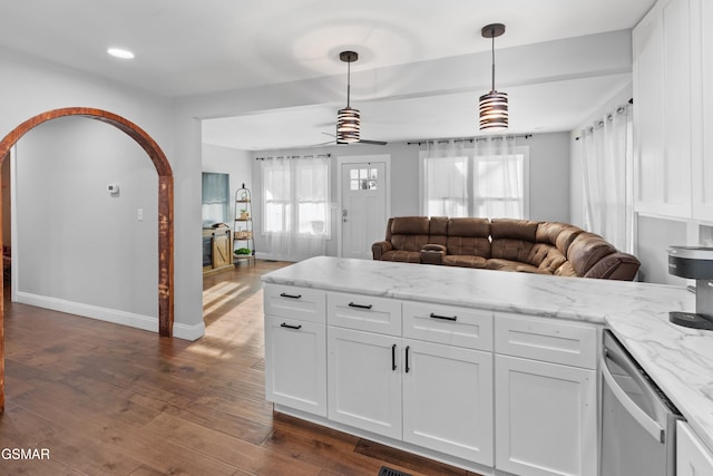 kitchen with white cabinetry, ceiling fan, dark wood-type flooring, hanging light fixtures, and light stone counters