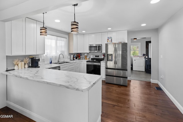 kitchen featuring white cabinets, appliances with stainless steel finishes, kitchen peninsula, and sink