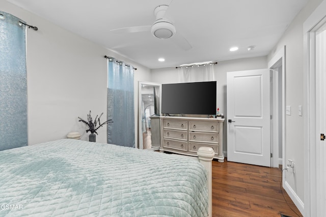 bedroom with ceiling fan, dark hardwood / wood-style flooring, and connected bathroom