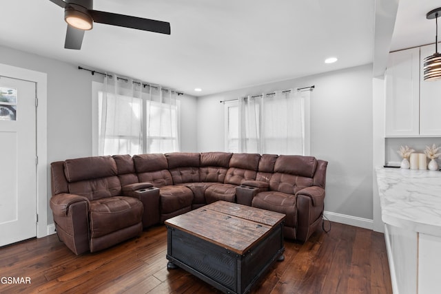 living room with dark hardwood / wood-style floors and ceiling fan