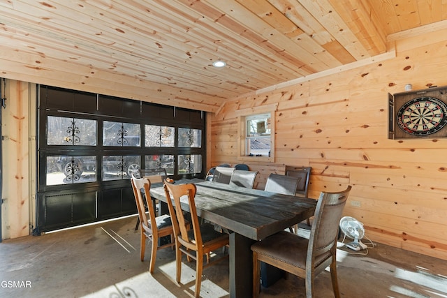 dining room with wooden ceiling and wooden walls