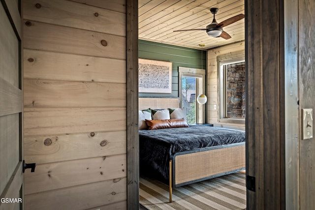 bedroom with wooden ceiling and wooden walls