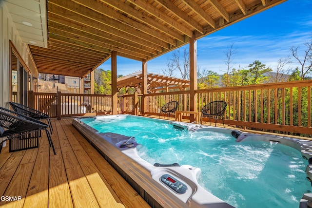 view of swimming pool with hot tub deck surround and a wooden deck