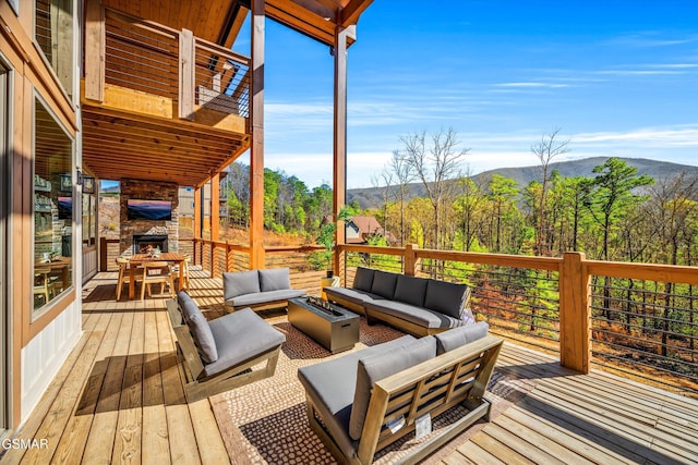 wooden terrace featuring a mountain view and an outdoor living space