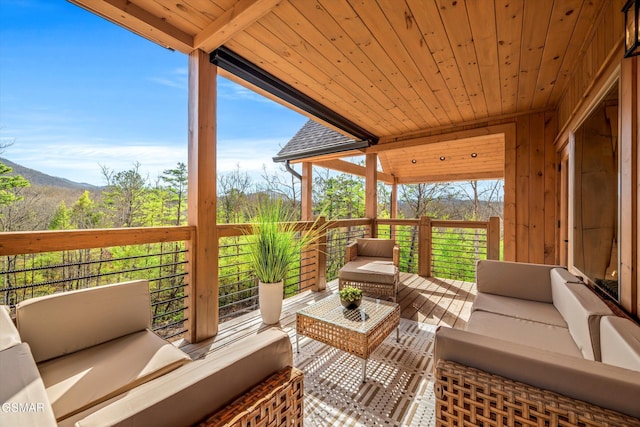 wooden terrace featuring an outdoor hangout area