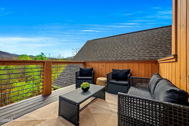 deck with outdoor lounge area and a mountain view