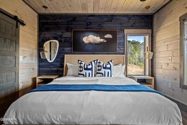 bedroom featuring wood ceiling, wooden walls, and a barn door