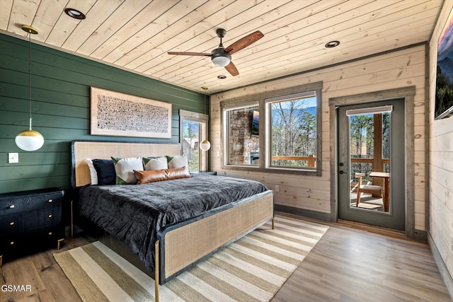 bedroom with access to exterior, wood ceiling, a ceiling fan, and wood finished floors