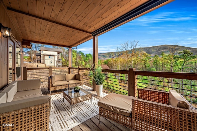 deck featuring outdoor lounge area and a mountain view