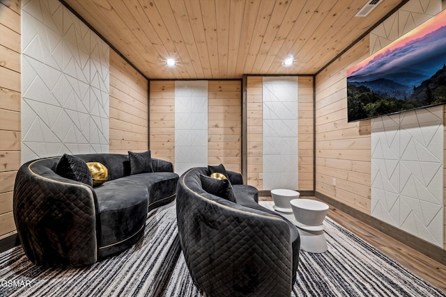 living area featuring visible vents, wood finished floors, wood ceiling, and wooden walls