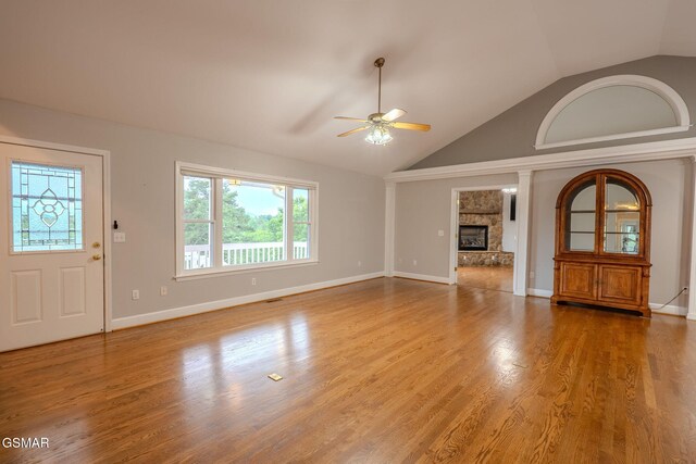 1110 Hide Away Ln, Kodak, TN 37764 - unfurnished living room with ceiling fan, a fireplace, wood finished floors, and high vaulted ceiling