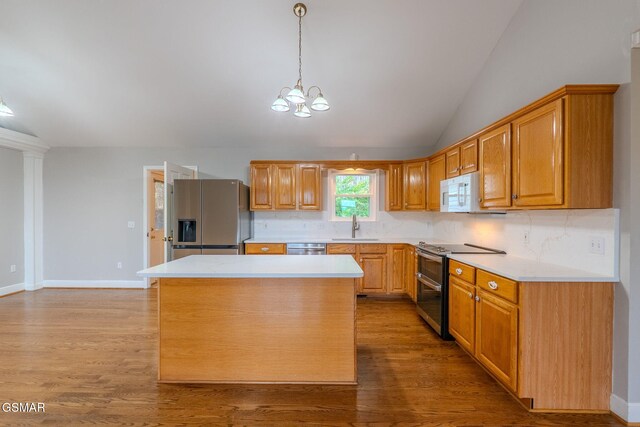 1110 Hide Away Ln, Kodak, TN 37764 - kitchen with stainless steel appliances, vaulted ceiling, tasteful backsplash, light countertops, and light wood-type flooring