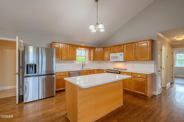 1110 Hide Away Ln, Kodak, TN 37764 - kitchen featuring stainless steel appliances, light countertops, backsplash, a chandelier, and dark wood-style floors