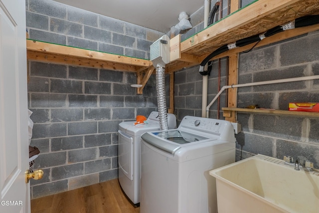 1110 Hide Away Ln, Kodak, TN 37764 - washroom featuring washer and clothes dryer, wood finished floors, and concrete block wall