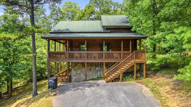 log cabin featuring a deck