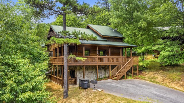 view of front of home featuring central air condition unit and a wooden deck