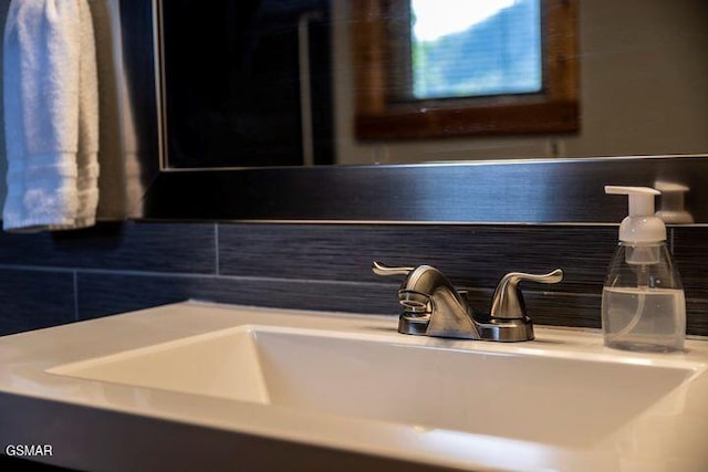 room details featuring a sink and tasteful backsplash