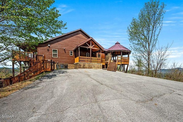 chalet / cabin with stairs and covered porch