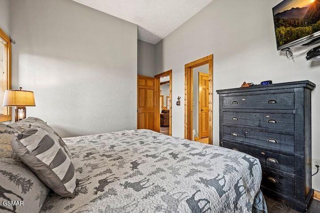 bedroom with baseboards and vaulted ceiling
