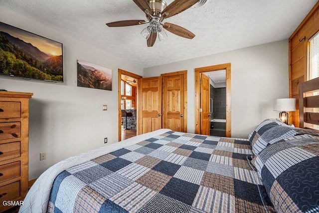 bedroom with ceiling fan, multiple windows, a textured ceiling, and connected bathroom