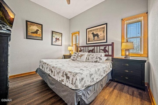 bedroom featuring baseboards, a ceiling fan, and dark wood finished floors