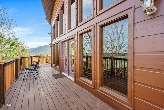wooden deck with french doors and a mountain view