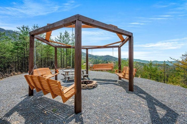 view of patio / terrace featuring a mountain view and a fire pit